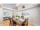 Elegant dining area with dark wood furniture, chandelier, and pass-through to other rooms at 14833 Vine St, Thornton, CO 80602