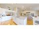 Bright, open kitchen features an island with granite countertops, stainless steel appliances, and wood floors at 14833 Vine St, Thornton, CO 80602