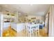 A bright kitchen with white cabinets, a center island, and stainless steel appliances, adjacent to a dining area at 14833 Vine St, Thornton, CO 80602