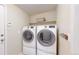 Convenient laundry room with modern, front-loading washer and dryer, shelf, and space-saving design at 14833 Vine St, Thornton, CO 80602