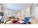 Comfortable living room area with accent chair, large windows and hardwood floors at 14833 Vine St, Thornton, CO 80602