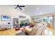 The spacious living room features a vaulted ceiling, hardwood floors, and a large bay window overlooking the front yard at 14833 Vine St, Thornton, CO 80602