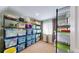 Well-organized storage room with metal shelving and clear plastic bins to keep items tidy and easily accessible at 14833 Vine St, Thornton, CO 80602