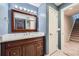 Bathroom with a wood vanity, a framed mirror, and modern lighting at 22019 E Arbor Dr, Aurora, CO 80016