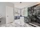 Luxury bathroom boasting marble floors, a glass shower, and a soaking tub with window views at 22019 E Arbor Dr, Aurora, CO 80016
