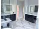Elegant bathroom with double vanity, marble counters, and illuminated mirrors at 22019 E Arbor Dr, Aurora, CO 80016