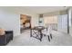 Versatile bonus room featuring neutral decor, a desk and sitting area, and views into the primary bedroom at 22019 E Arbor Dr, Aurora, CO 80016