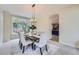 Elegant dining room with a large window, chandelier and neutral decor at 22019 E Arbor Dr, Aurora, CO 80016