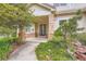 Inviting front entrance with a glass-paneled door, brick accents, and well-maintained landscaping at 22019 E Arbor Dr, Aurora, CO 80016