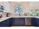 Well-lit kitchen showcasing stainless steel appliances, sleek countertops, and mosaic tile backsplash at 22019 E Arbor Dr, Aurora, CO 80016