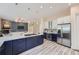 Modern kitchen with large island, stainless steel appliances and an adjacent living room at 22019 E Arbor Dr, Aurora, CO 80016