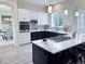 Modern kitchen with stainless appliances, quartz counters and two-tone cabinets at 22019 E Arbor Dr, Aurora, CO 80016