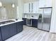 Well-appointed kitchen with large refrigerator, wine cooler, and granite countertops at 22019 E Arbor Dr, Aurora, CO 80016