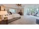 Serene primary bedroom showcasing a sitting area with bay windows and a comfortable, king-sized bed at 22019 E Arbor Dr, Aurora, CO 80016