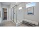 Modern bathroom features a glass enclosed shower, neutral tiling, and a bench creating a spa-like experience at 9972 Wheeling St, Commerce City, CO 80022