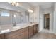 Bathroom features double sinks, large mirror, and tiled floors at 9972 Wheeling St, Commerce City, CO 80022