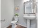 Stylish powder room features a pedestal sink, modern fixtures, and decor creating a convenient and aesthetically pleasing space at 9972 Wheeling St, Commerce City, CO 80022