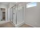 A frameless glass shower featuring white tile surround and a shower niche at 9972 Wheeling St, Commerce City, CO 80022