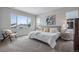 Bright bedroom features a comfortable bed with decorative pillows, natural light, and a calm aesthetic for a restful environment at 9972 Wheeling St, Commerce City, CO 80022