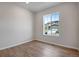 Bedroom with wood floors, light colored walls, and a view of the neighborhood at 9972 Wheeling St, Commerce City, CO 80022