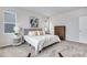 Bedroom features a plush bed with decorative pillows, natural light, and a calm aesthetic for a restful environment at 9972 Wheeling St, Commerce City, CO 80022