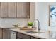 Close-up of kitchen island with a modern sink and a tray with decorative elements at 9972 Wheeling St, Commerce City, CO 80022