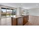 Bright, modern kitchen with island, stainless steel appliances, and sliding glass doors at 9972 Wheeling St, Commerce City, CO 80022