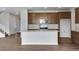 Kitchen island with sink and white countertop at 9972 Wheeling St, Commerce City, CO 80022