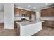 Contemporary kitchen featuring shaker cabinets, stainless appliances, and a spacious center island at 9972 Wheeling St, Commerce City, CO 80022