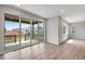 Living room with sliding glass doors leading to a balcony with a view at 9972 Wheeling St, Commerce City, CO 80022