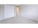 A bright bedroom featuring a neutral color scheme, carpeted floor and closet with bi-fold doors at 9005 E Lehigh Ave # 16, Denver, CO 80237