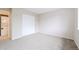 Bedroom featuring plush carpeting, fresh neutral walls, a stacked washer-dryer in the hall, and a large closet at 9005 E Lehigh Ave # 16, Denver, CO 80237
