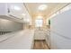 Cozy kitchen featuring a breakfast bar, a window overlooking the front yard, white appliances, and wood-look vinyl floors at 9005 E Lehigh Ave # 16, Denver, CO 80237