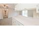 The kitchen offers white cabinets, a breakfast bar overlooking the living room, and ample counter space for meal preparation at 9005 E Lehigh Ave # 16, Denver, CO 80237