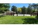 Exterior view of a community pool surrounded by manicured lawns and mature trees at 9005 E Lehigh Ave # 16, Denver, CO 80237