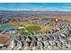 Neighborhood aerial view featuring community park with pool and play area, surrounded by homes and scenic mountain backdrop at 802 Eva Peak Dr, Erie, CO 80516