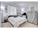 Cozy bedroom features a queen-sized bed, carpeted floor and a window with natural light at 802 Eva Peak Dr, Erie, CO 80516