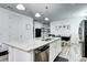 Modern kitchen features granite island, stainless appliances, and bright dining area at 802 Eva Peak Dr, Erie, CO 80516