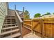 Stairs up to a wooden deck, adjacent to a wood fence and small patch of mulch at 5721 W 92Nd Ave # 96, Westminster, CO 80031