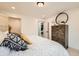 Bedroom features stylish decor with modern furnishings, including bed, dresser and circular mirror at 5721 W 92Nd Ave # 96, Westminster, CO 80031