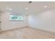 Bright, empty room with laminate floors, neutral paint, a window and recessed lighting at 5721 W 92Nd Ave # 96, Westminster, CO 80031