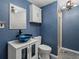 Bright blue bathroom with a vessel sink and storage cabinet at 21258 E Aberdeen Pl, Centennial, CO 80015