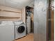 Functional laundry area featuring a washer, dryer, shelving, and water heater for efficient home management at 21258 E Aberdeen Pl, Centennial, CO 80015