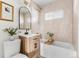 Modern bathroom with light-colored tile and a light wood vanity at 3088 S Grape Way, Denver, CO 80222