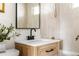 Modern bathroom vanity with a black faucet and a white countertop at 3088 S Grape Way, Denver, CO 80222