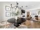 Modern dining area with round table, black chairs, and contemporary chandelier at 3088 S Grape Way, Denver, CO 80222