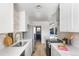 Modern kitchen with white cabinets, quartz countertops, and a gold faucet at 3088 S Grape Way, Denver, CO 80222