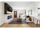 Modern living room with fireplace, hardwood floors, and stylish decor at 3088 S Grape Way, Denver, CO 80222