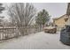 Spacious wooden deck featuring a wood railing and views of the surrounding trees and landscape at 2522 W Dry Creek Ct, Littleton, CO 80120