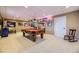 Finished basement with a pool table, carpeted floors, and decorative neon signs at 2522 W Dry Creek Ct, Littleton, CO 80120